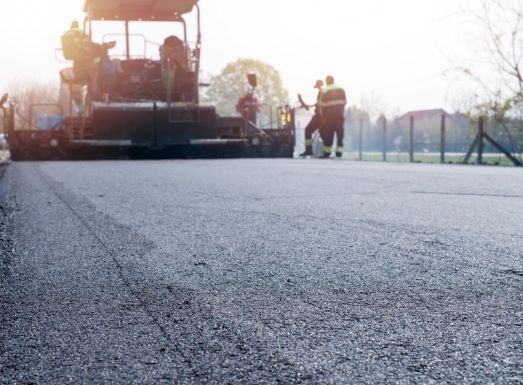 blacktop paving machine with some workers georgetown de