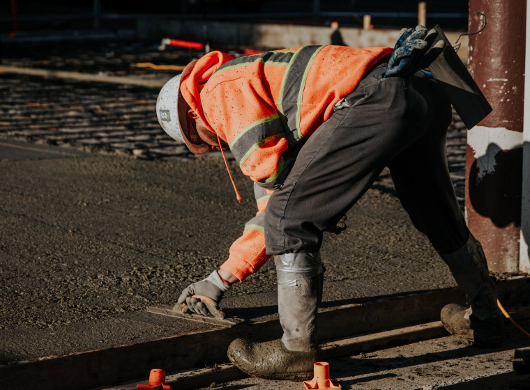 worker applying blacktop sealcoating georgetown de